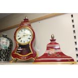 A REPRODUCTION FRENCH BOMBE SHAPED CLOCK AND SHELF WITH HAND PAINTED FLORAL DECORATION