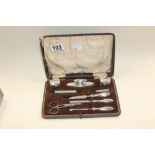 AN UNUSUAL CASED SILVER MOUNTED MANICURE SET, HALLMARKED BIRMINGHAM 1922, MAKERS MARK RUBBED