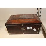 A WILLIAM IV ROSEWOOD SARCOPHAGUS TEA CADDY INLAID WITH MOTHER OF PEARL DECORATION AND KEY