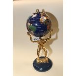 A NOVELTY GLOBE IN THE FORM OF THE GREEK GOD ATLAS HOLDING THE WORLD ALOFT, 37CM HIGH