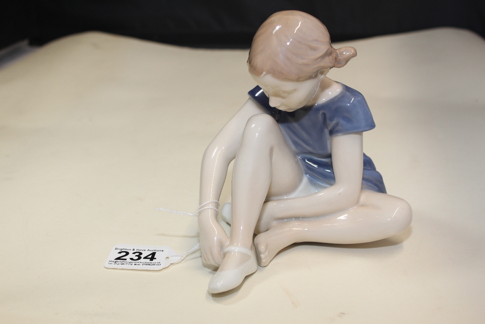 A ROYAL COPENHAGEN PORCELAIN FIGURE OF A SEATED GIRL, #4642, 15CM HIGH