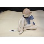 A ROYAL COPENHAGEN PORCELAIN FIGURE OF A SEATED GIRL, #4642, 15CM HIGH