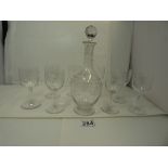 A SET OF EIGHT BACCARAT CRYSTAL PORT GLASSES AND A DECANTER, EACH WITH ETCHED DECORATION OF