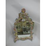 AN EARLY 20TH CENTURY PORCELAIN MOUNTED MIRROR, HIGHLY DECORATED WITH FLOWING FOLIAGE THROUGHOUT,