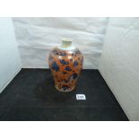 A CHINESE PORCELAIN VASE DECORATED IN ORANGE AND BLUE AND BEARING THE SIX CHARACTER XUANTONG