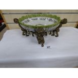 A LATE VICTORIAN LARGE CERAMIC DISH SAT UPON A BRONZE BASE DEPICTING FOUR CHERUBS, 41CM WIDE 16.