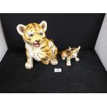 TWO ITALIAN PORCELAIN FIGURES OF TIGERS, LARGEST 25.5CM HIGH (AF)