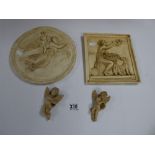 TWO CIRCULAR WALL PLAQUES AND TWO WALL HANGING FIGURES, ALL DEPICTING CHERUBS