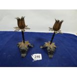 A PAIR OF BLACK PAINTED METAL AND BRASS CANDLESTICKS, 17.5CM HIGH