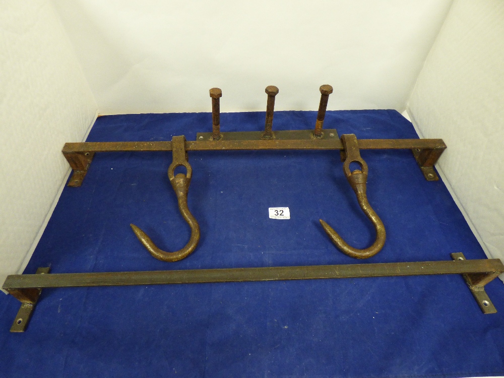 TWO HEAVY BUTCHERS MEAT HOOKS, TWO RAILS AND A THREE HOOK COAT RACK, THE HOOKS BEING LARGE BOLTS