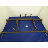 TWO HEAVY BUTCHERS MEAT HOOKS, TWO RAILS AND A THREE HOOK COAT RACK, THE HOOKS BEING LARGE BOLTS