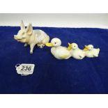 A BESWICK FIGURE OF A SEATED PIG, NO 832, TOGETHER WITH ANOTHER BESWICK FIGURE OF THREE DUCKS