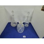 THREE CUT GLASS DECANTERS OF VARYING SHAPES AND SIZES, ONE WITH ORIGINAL LABEL “GUARANTEED HAND