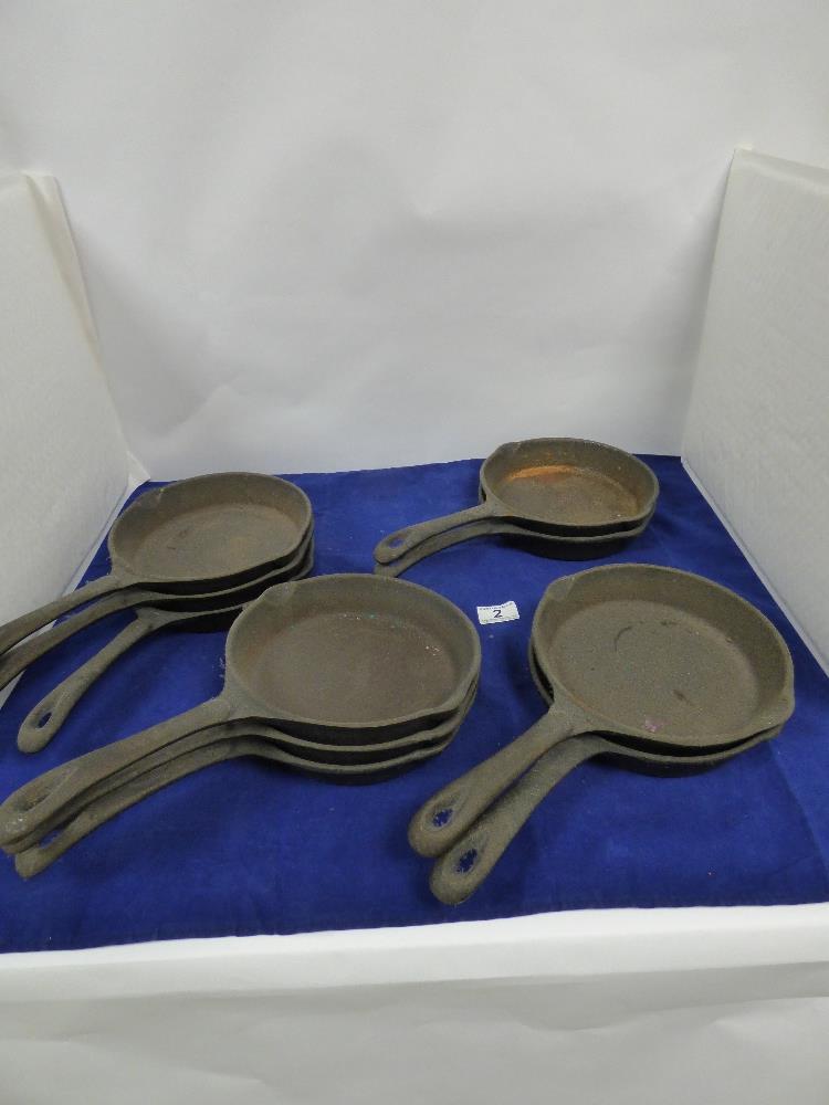 TEN CAST IRON SKILLET PANS, 36CM LONG