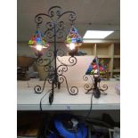 A WROUGHT IRON AND COLOURED GLASS DUAL LIGHT LAMP TOGETHER WITH ANOTHER SINGLE LAMP OF MATCHING