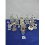 A LARGE QUANTITY OF CUT GLASS BOTTLES INCLUDING THOSE FOR PERFUME, CRUETS, ATOMISERS AND A PAIR OF