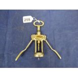 A VINTAGE CORKSCREW BOTTLE OPENER, THE FRONT APPEARING TO READ “GUCCI”, 20.5CM LONG