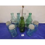 A VINTAGE METAL FOUR BOTTLE CARRIER WITH FOUR GLASS BOTTLES, TOGETHER WITH FIVE OTHER GLASS ITEMS