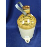 A STONEWARE WATER CONTAINER WITH WRITING TO TOP “SALUTARIS WATER CO, DISTILLERY, 236 FULHAM ROAD