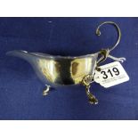 A SILVER SAUCE BOAT RAISED ON THREE FEET, MARKED TO BASE “STIRLING” 55G IN WEIGHT