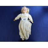 A SCHOENAU AND HOFFMEISTER BISQUE HEAD DOLL ON STRAW STUFFED CLOTH BODY WITH COMPOSITION HANDS