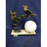 AN ART DECO STYLE TABLE LAMP WITH RAISED UPON A MARBLE BASE, UPON WHICH A LARGE METAL BIRD AND