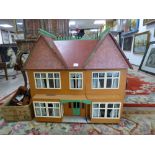 A LARGE VINTAGE DOUBLE FRONTED THREE STOREY DOLLS HOUSE WIRED FOR LIGHTING WITH A QUANTITY OF