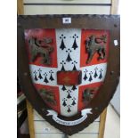 A LARGE WOODEN CAMBRIDGE UNIVERSITY CREST, RED AND WHITE PAINTED, MOUNTED TO WOODEN BACK, 75CM BY