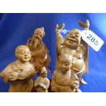 FIVE ASIAN ORIENTAL TREEN FIGURES OF A STRETCHING BUDDHA, TWO CHILDREN, AN ELDERLY GURU AND A
