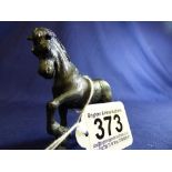 A BLACK PAINTED LEAD FIGURE OF A PRANCING HORSE, 8CM WIDE BY 7CM HIGH