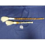 TWO EARLY 20TH CENTURY HORSE HAIR CALLIGRAPHY BRUSHES WITH LONG HANDLES, ONE HANDLE BEING WOODEN,