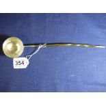 A GEORGIAN WHITE METAL TODDY LADLE WITH AN INSET COIN TO BOWL DATED 1757, 30CM LONG