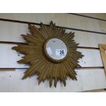 AN ART DECO STYLE GILT WOOD SUN BURST MIRROR, 32CM IN DIAMETER