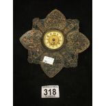 A VICTORIAN STAR SHAPED CLOCK, WORN VELVET BACK WITH INLAID BRASS DECORATION TO THE FRONT, THE CLOCK
