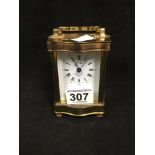 A FRENCH BRASS CARRIAGE CLOCK WITH SERPENTINE OUTLINE BY L'EPEE, 12CM HIGH
