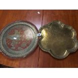 TWO MIDDLE EASTERN BRASS TRAYS WITH ENGRAVED DECORATION THROUGHOUT, LARGEST 40CM DIAMETER