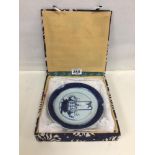 AN EARLY CHINESE PLATE WITH A HAND PAINTED BLUE AND WHITE SCENE TO THE FRONT DEPICTING FLOWERS,