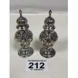 A PAIR OF EDWARDIAN SILVER EMBOSSED PEPPER POTS OF BALUSTER FORM, HALLMARKED BIRMINGHAM 1901 BY