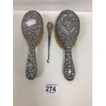 TWO HALLMARKED SILVER HAIR BRUSHES WITH EMBOSSED DECORATION AND A SIMILAR BUTTON HOOK