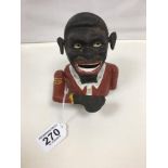 A NOVELTY CAST IRON MONEY BANK FORMED AS A MAN, 15CM HIGH