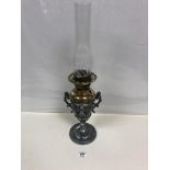 AN UNUSUAL OIL LAMP WITH WHITE METAL TWIN HANDLED URN SHAPED BASE IN THE CLASSICAL STYLE, 54.5CM