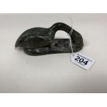 A 20TH CENTURY INUIT SOAPSTONE CARVING OF A GOOSE PROTECTING ITS EGGS, INDISTINGCTLY SIGNED TO THE