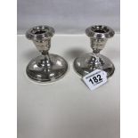 A PAIR OF STERLING SILVER SQUAT CANDLE STICKS, MARKED TO BASES; FISHER STERLING WEIGHTED 811, 9.5CM
