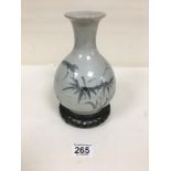 AN EARLY CHINESE VASE OF BALUSTER FORM WITH HAND PAINTED FLORAL MOTIFS, RAISED ON WOODEN BASE,