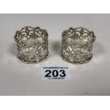 A PAIR OF SILVER NAPKIN RINGS WITH ORNATELY PIERCED AND FLOWING DETAILING THROUGHOUT, HALLMARKED