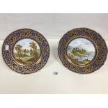 A PAIR OF 19TH CENTURY PORCELAIN WALL PLATES WITH HAND PAINTED SCENES OF OF ABBEY RUINS WITHIN A