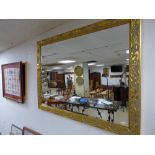 A LARGE GILT FRAMED "CHABLIS" MIRROR WITH LEAF DETAILING, BATCH NO 302, 115CM BY 90CM