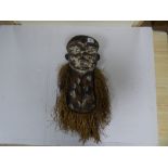 A CONGOLESE CARVED WOODEN MASK WITH STRAW DETAILING