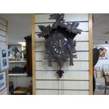 A BLACKFOREST STYLE CUCKOO CLOCK, COMPLETE WITH WEIGHTS AND PENDULUM (AF)
