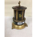 A VINTAGE NOVELTY MUSICAL CIGARETTE HOLDER, RAISED UPON BRASS BASE, INLAID DECORATION TO EACH OF THE